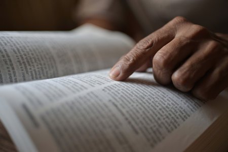 A black man is reading the scriptures or the Holy Bible. The teachings of God according to belief and faith in God. Concept of Religion and faith. Christianity, Islam, Judaism.の写真素材