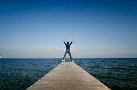 A person enjoying a sunny day on the seafront in Copenhagen.の写真素材