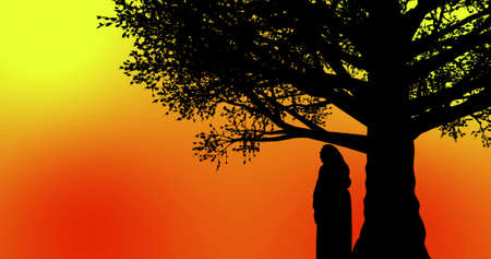 Beautiful woman standing under a tree during sunset time orange yellow backgroundの写真素材