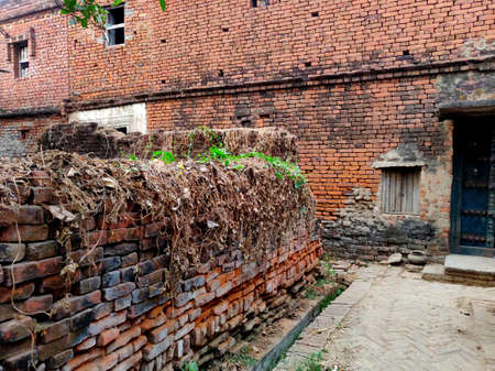 An old village house wall made up of red bricks in Indiaの写真素材