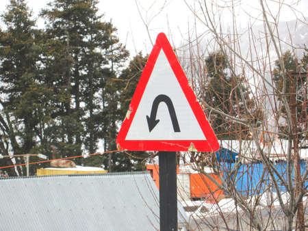 U-Turn Road Signage Board in a mountainous region around a curve mountainの写真素材