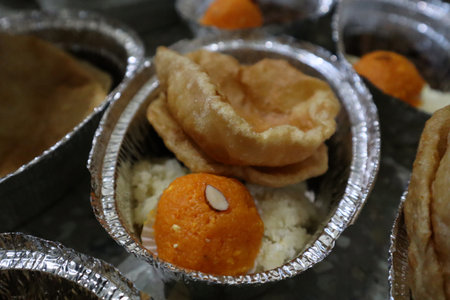Prasad Plate with Puri, Ladoo, and RiceA prasad plate containing puris, orange ladoo, rice, and kala chana â offered during Hindu religious rituals.の写真素材