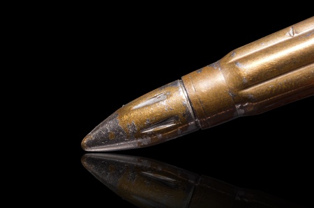 Old rifle bullet, isolated over black の写真素材