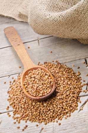 buckwheat groats and wooden spoonの写真素材