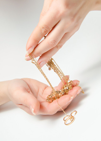 Hand Holding Expensive Gold Jewelryの写真素材