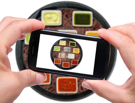 Hands taking photo sauces with smartphoneの写真素材