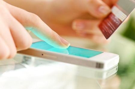Woman is shopping online with cell phone.の写真素材