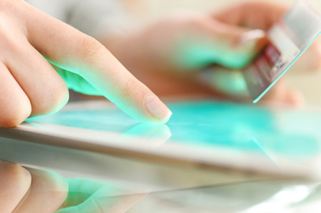 Woman is shopping online with tablet pcの写真素材