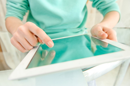 Hand touching screen on modern digital tablet pc.の写真素材