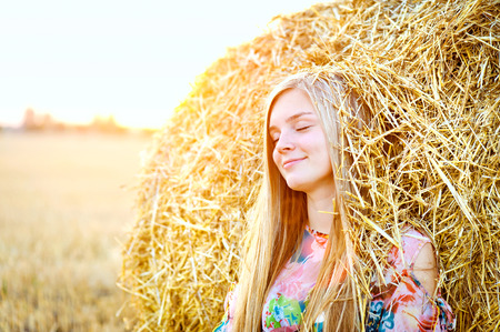 Romantic young woman posing outdoor.の写真素材