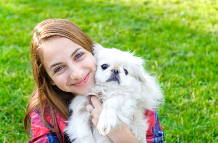 Beautiful girl with dog taken pictures of her self, instagramの写真素材