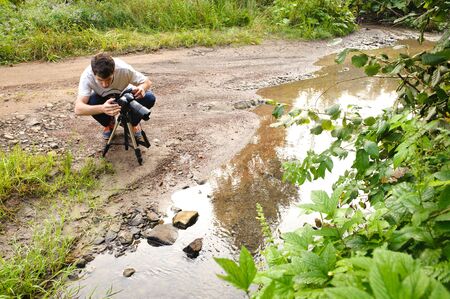 Photo of young man photographer with photo camera.の写真素材
