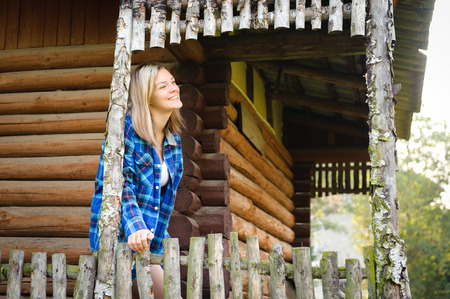 Attractive woman in the wooden house, relaxed summery atmosphereの写真素材