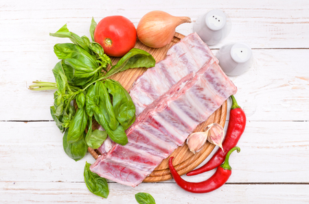 Raw pork rib meat on wooden board.の写真素材