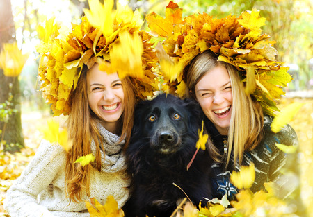 Girls with a dog in the parkの写真素材
