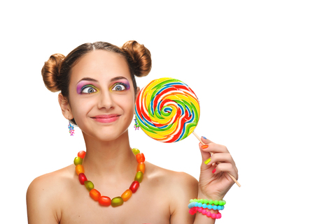 Girl eating colourful lollipop. Lollipop. Isolated on white backgroundの写真素材