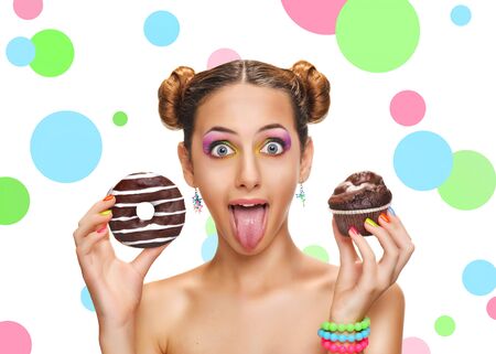Beautiful girl with colorful donut and muffin.の写真素材