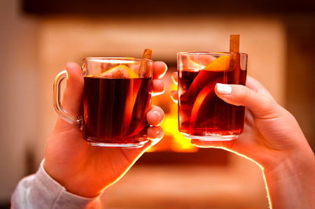 Wine by the fireplace, glasses of mulled wine.の写真素材
