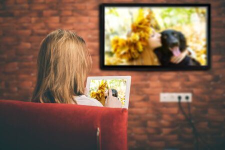 Closeup of a tablet is connected to a smart TV.