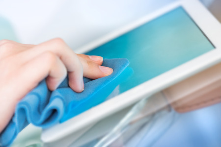 Cleaning screen on modern digital tablet pc.