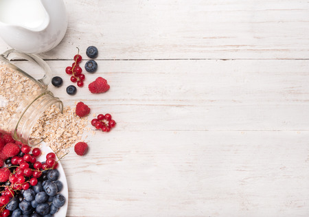 Smoothies with oatmeal, berries in glass jars on a wooden background.の写真素材