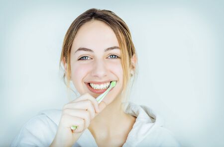 Happy young woman brushing teeth.の写真素材