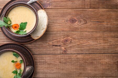 Pea soup in the bowl on a rustic wooden background.の写真素材
