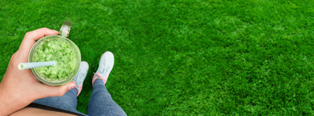 Young girl drinking fruit smoothie.の写真素材