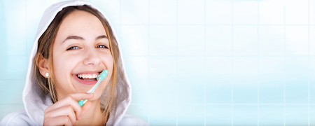 Happy young woman brushing teeth.の写真素材