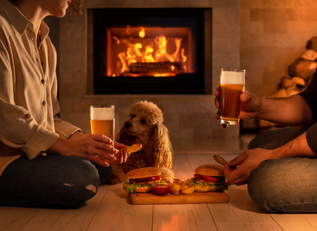 Young couple have a romantic dinner with hamburgers and beer.の写真素材
