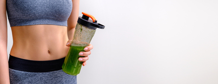 Young woman drinking smoothie after workout.の写真素材