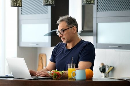 Man working using a laptop at home.の写真素材