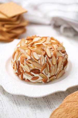 Homemade classic cheese ball with crackers.