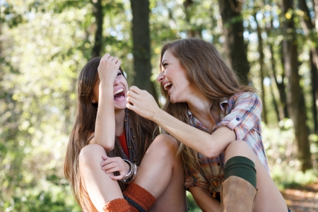 two girlfriends outdoor laughingの写真素材