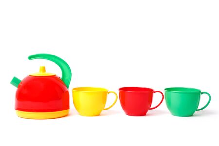teapot and three cups in row toys isolated on whiteの写真素材