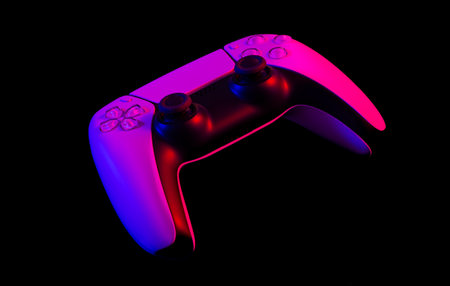 Modern white gamepad illuminated red and blue on a dark background.の写真素材