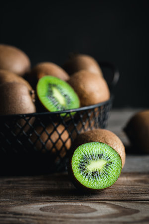 Close-up, whole kiwi and half in a basket.の写真素材