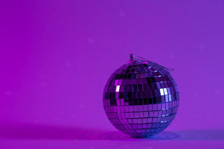 Disco ball on a blurred purple background, copy space.