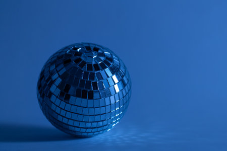 Disco ball on a blurred blue background, copy space.