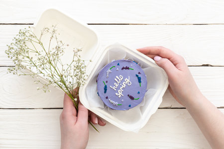 Delicious bento cake Hello spring on white wooden background, copy space.の写真素材