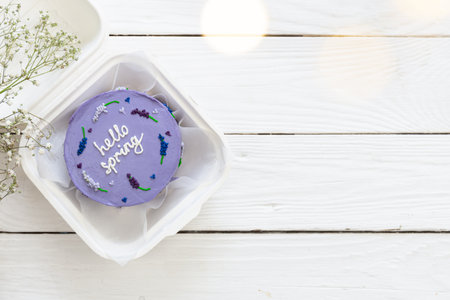 Delicious bento cake Hello spring on white wooden background, copy space.の写真素材