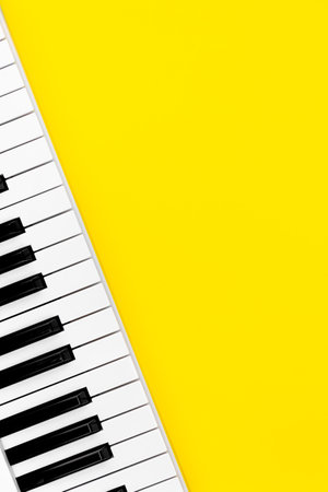 Piano keys on a yellow background, top view, flat lay.の写真素材