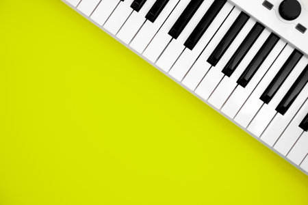 Midi keyboard on green background, flat lay, copy space.の写真素材