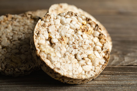 Stack of crunchy rice cakes on wooden table, healthy food concept.の写真素材