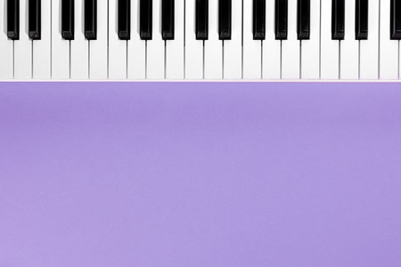 Piano keys on a lilac background, top view, flat lay, copy space.の写真素材