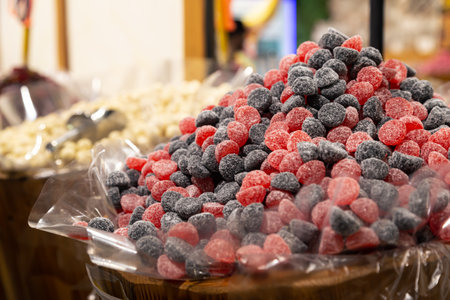 Close up of red and black candy in container in candy shop.の写真素材