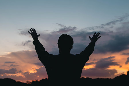 A man raises his hands to the sky, thanks God.の写真素材