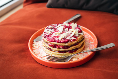 Homemade pancakes with raspberry jam on a plate, breakfast in bed.の写真素材
