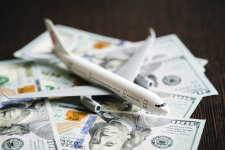Airplane and money. Plane on the background of USA dollars.の写真素材