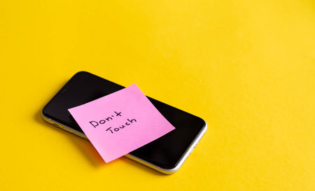 Inscription Dont touch on a paper reminder on smartphone.の写真素材